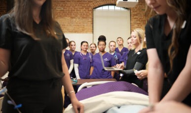 Group of nursing students watching demonstration.